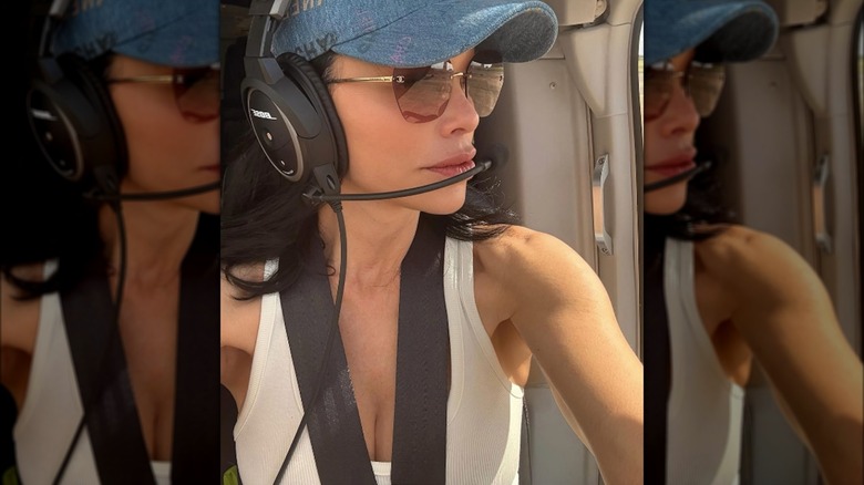 Lauren Sanchez wearing mirrored sunglasses while piloting a helicopter