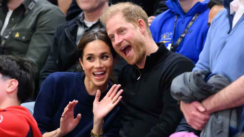 Meghan Markle and Prince Harry smiling with open mouths