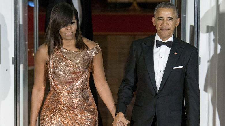 Michelle Obama in Versace dress poses next to Barack Obama in October 2016