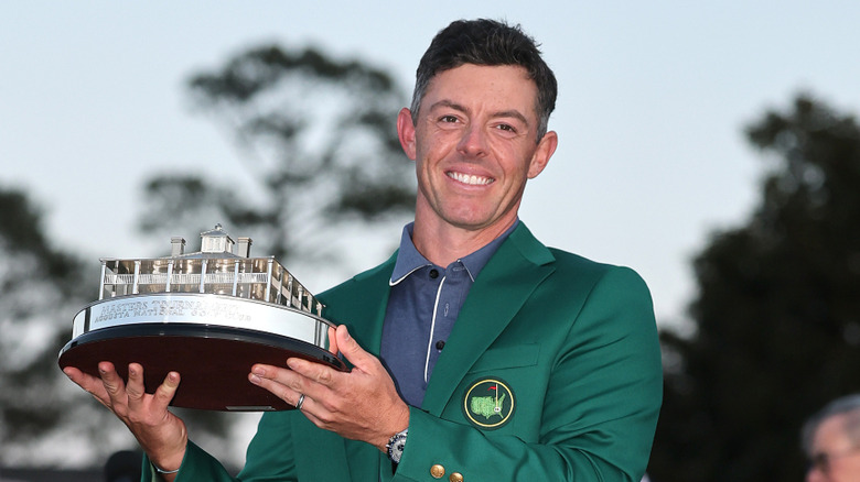 Rory McIlroy holding his Masters trophy.
