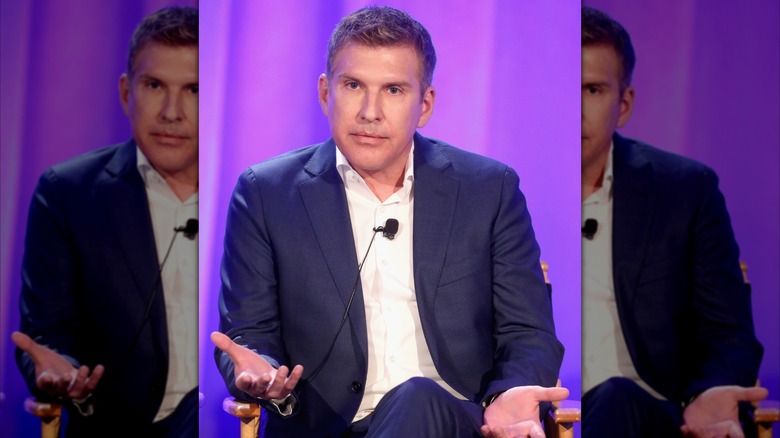 Todd Chrisley gestures with his hands while on stage.