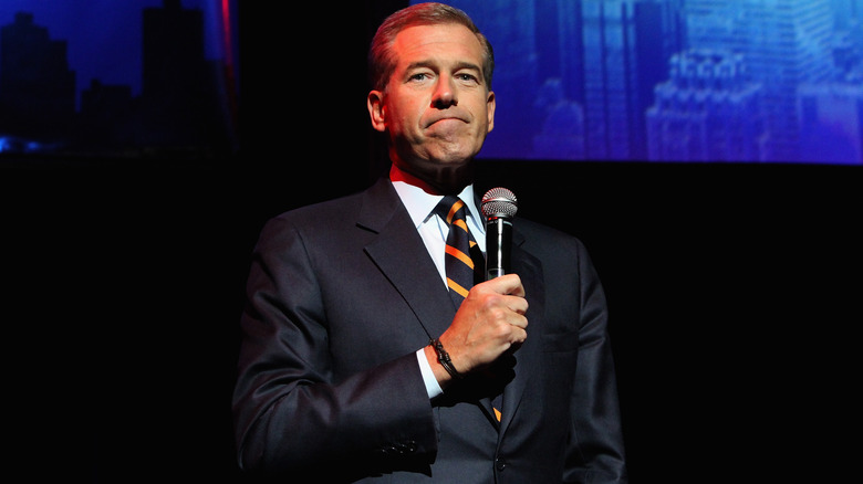 Brian Williams holding mic