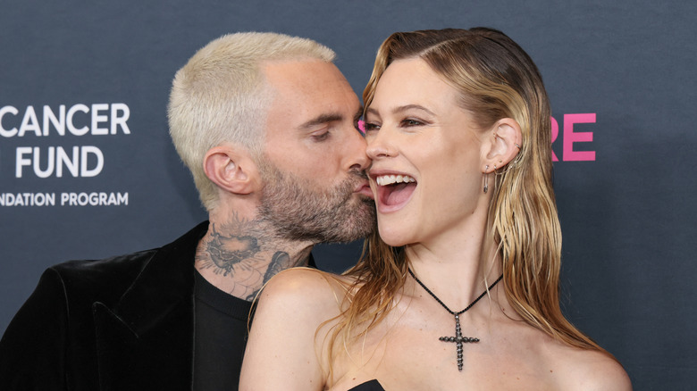 Adam Levine kissing Behati Prinsloo on the cheek