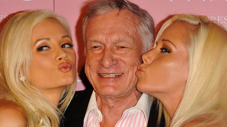 Hugh Hefner kissed by playmates