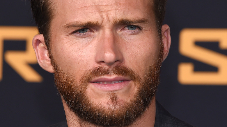 Scott Eastwood posing for photo at event