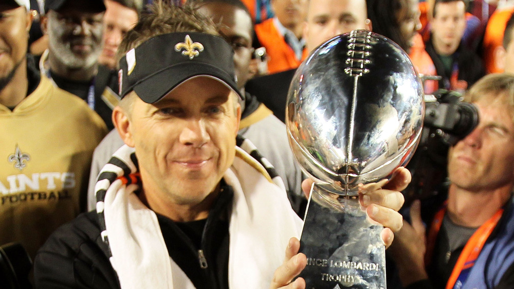 Sean Payton holding Super Bowl trophy