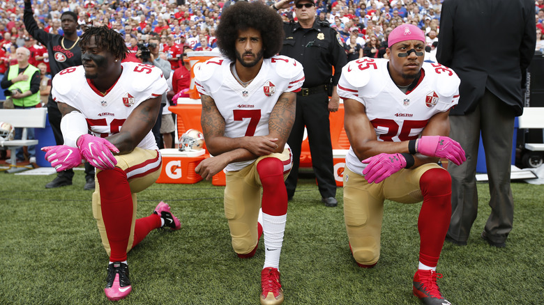 Colin Kaepernick kneeling with teammates