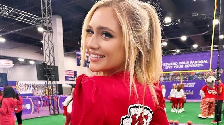 Maggie Sajak poses in a Chiefs jacket ahead of the Super Bowl