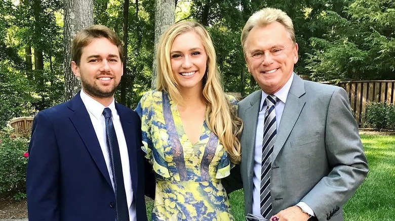 Maggie poses with her dad and brother