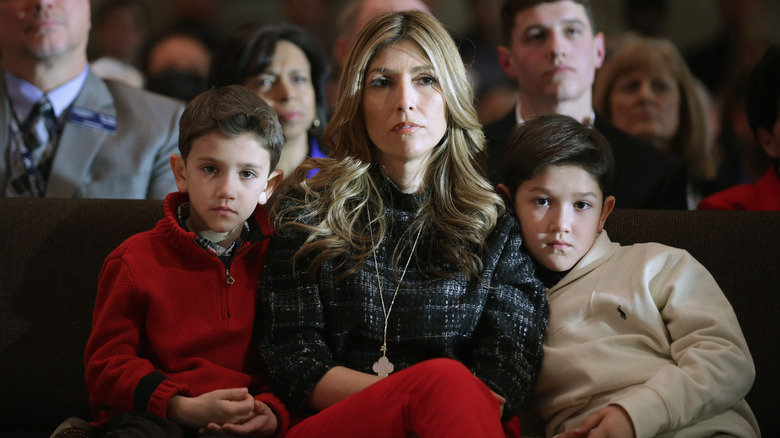 Jeanette Rubio (C), wife of Republican presidential candidate Sen. Marco Rubio (R-FL), and their sons Dominick (L), 8, and Anthony, 10, watching the senator during a campaign town hall meeting at the Southside Christian School