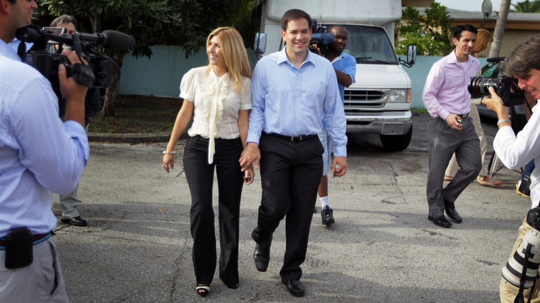 Marco Rubio (R), Republican candidate for Florida's U.S. Senate seat, walking with his wife, Jeanette Rubio, after voting on primary day