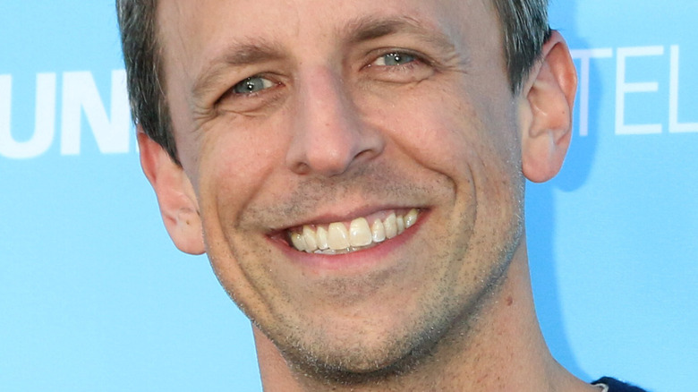 Seth Meyers smiles at an event