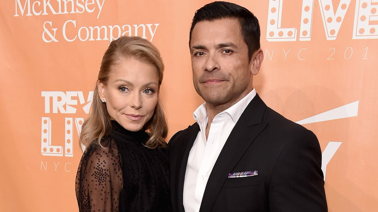 Kelly Ripa and Mark Consuelos wearing black on the red carpet