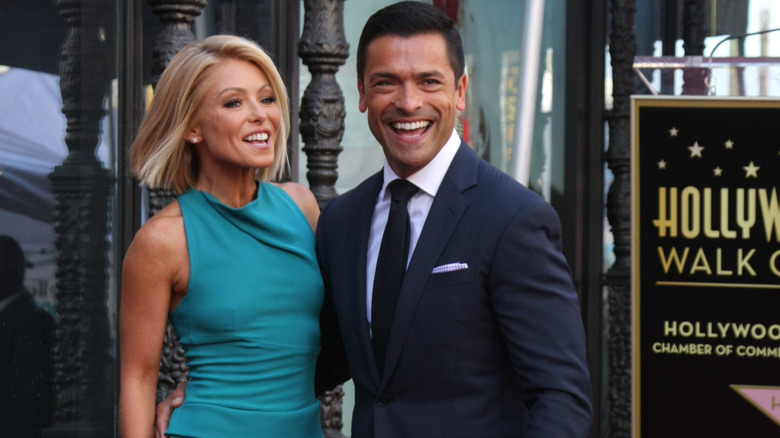 Kelly Ripa and Mark Consuelos posing outdoors
