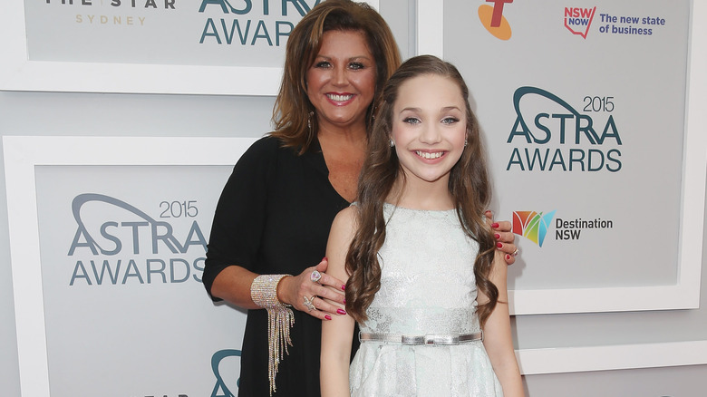 Abby Lee Miller and Maddie Ziegler smiling together at event