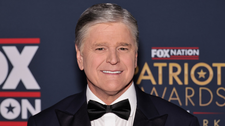 Sean Hannity smiling on a 2024 red carpet.