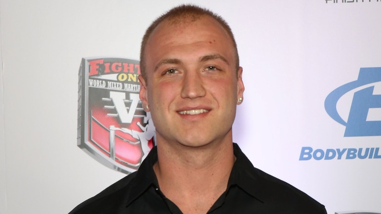 Nick Hogan is all smiles while sporting short dyed hair and a set of earrings.