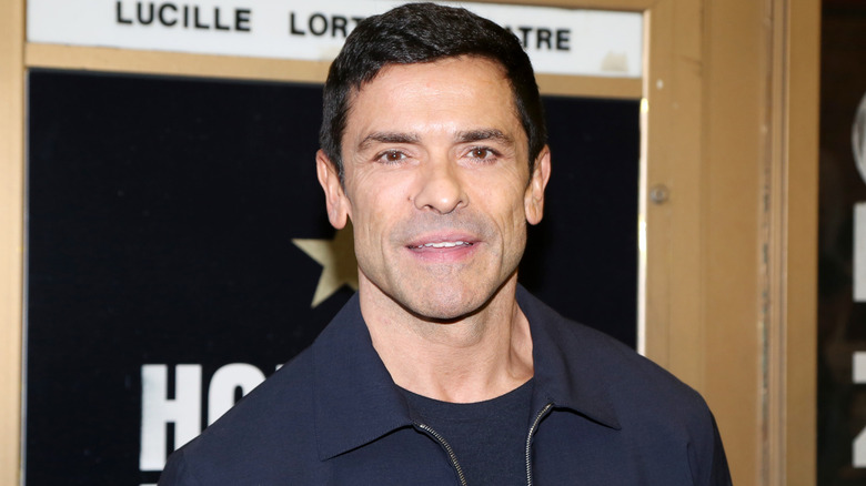 Mark Consuelos posing for cameras in navy jacket