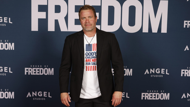 Tim Ballard wears black necklace