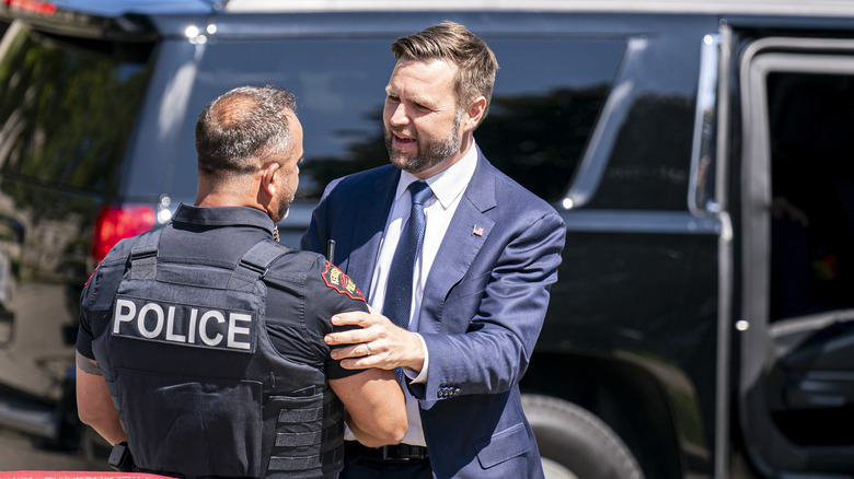 JD Vance greets a police officer in 2024