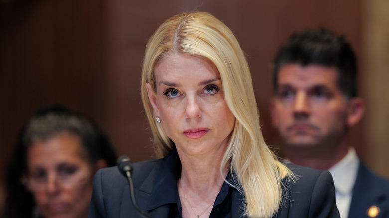 Pam Bondi testifying near a microphone