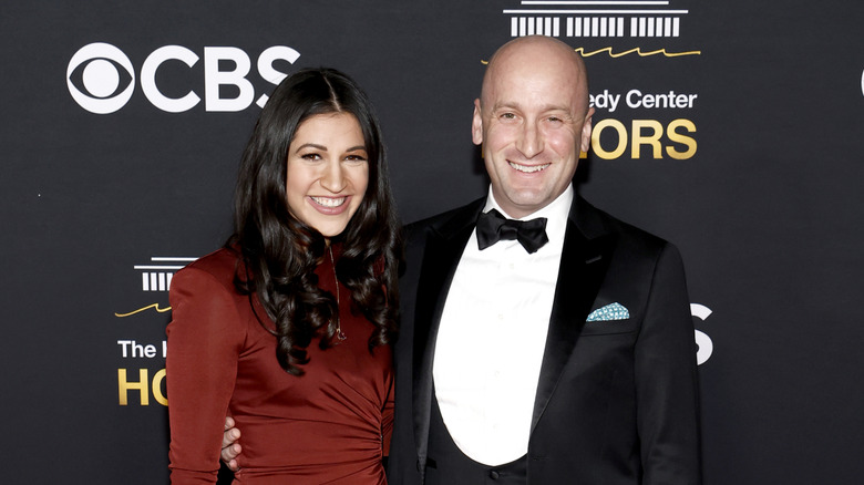 Stephen and Katie Miller smiling while posing together in their finery