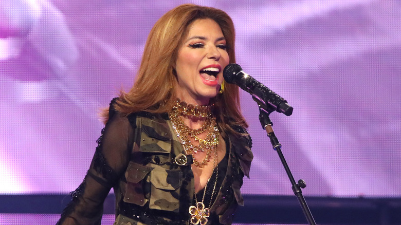 Shania Twain singing into a microphone