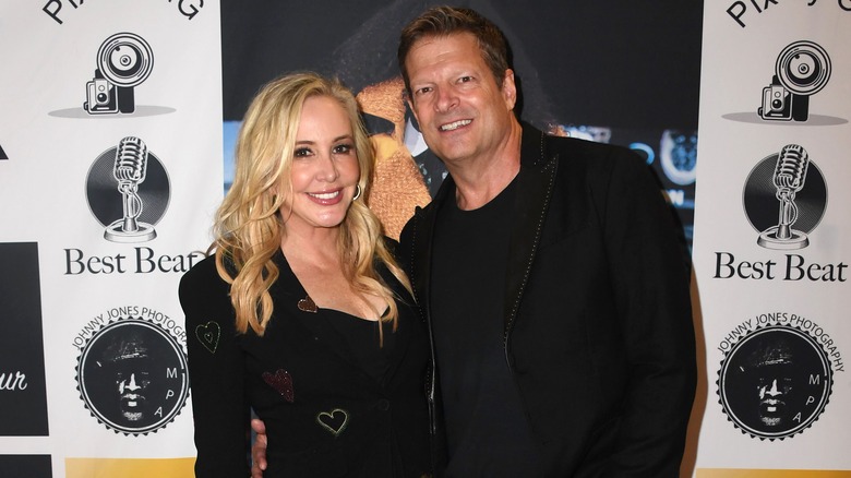 Shannon Beador and John Janssen pose on a red carpet