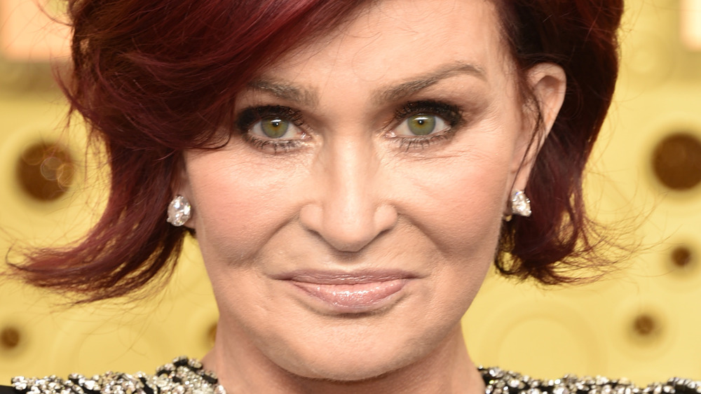 Sharon Osbourne stares into the camera while posing on the red carpet