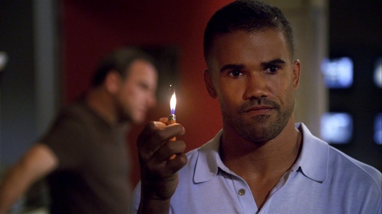Shemar Moore holding a lighter on Criminal Minds