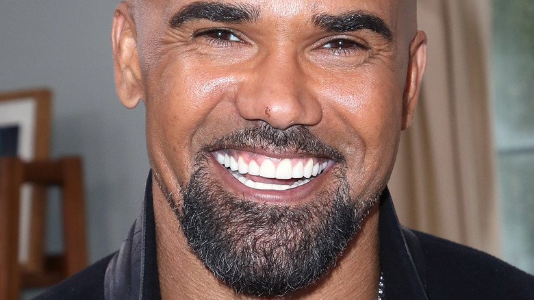 Shemar Moore smiling in leather jacket 