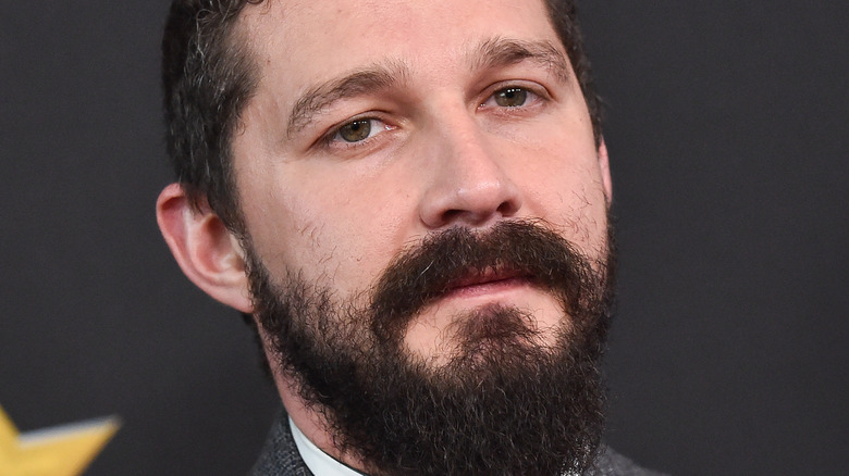 Shia LaBeouf poses with grown beard and mustache