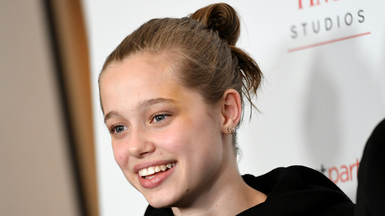 Shiloh Jolie-Pitt top knot smiling