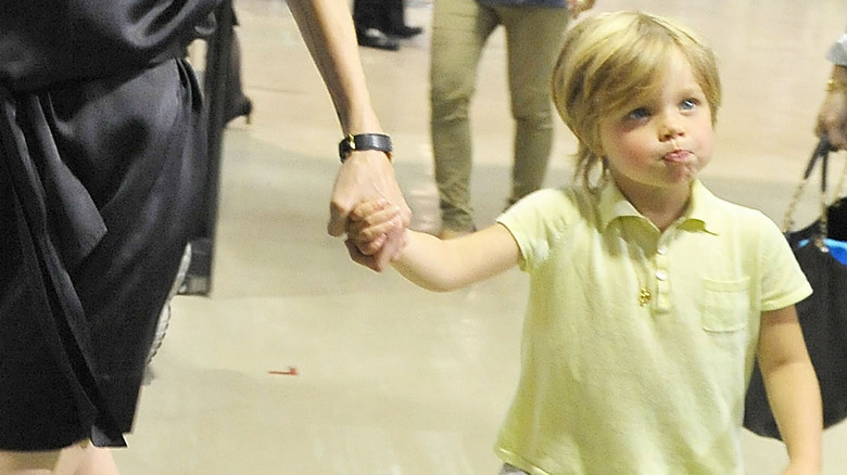 Shiloh Jolie-Pitt holding mom's hand