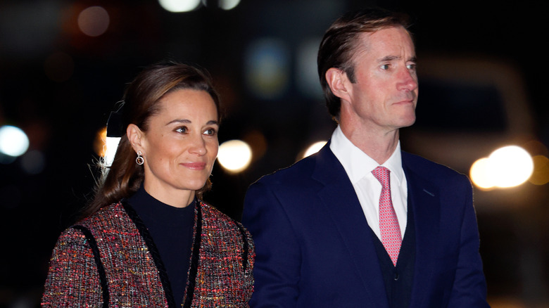 Pippa Middleton walks next to James Matthews in December 2023