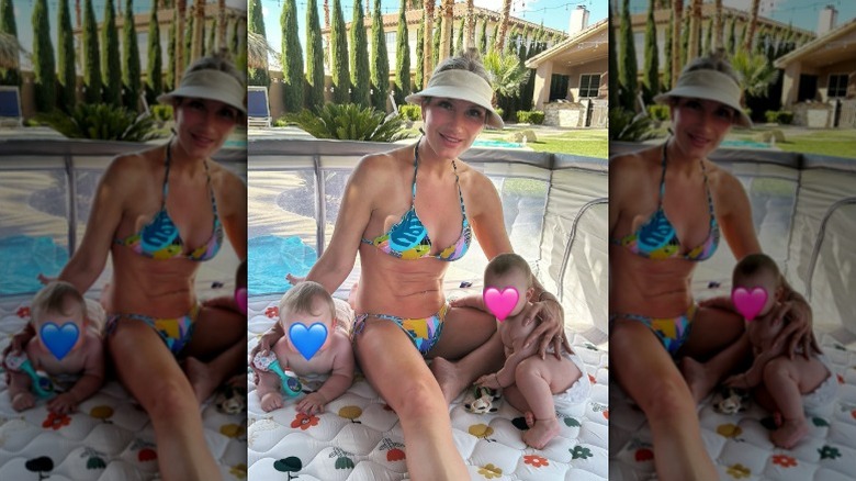 Brooke Hogan sitting beside a pool with her twins.