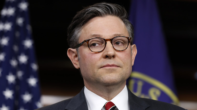 Mike Johnson looks sideways during news conference in 2024