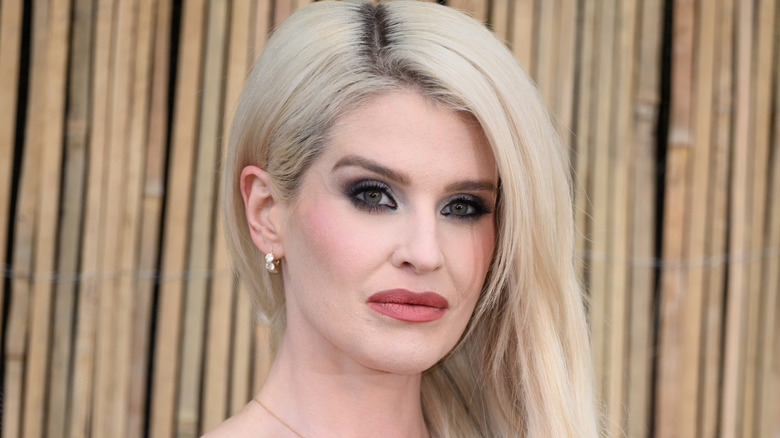 Kelly Osbourne posing with hair swept over shoulder