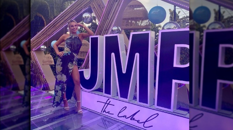 Juliette Porter in front of JMP advert