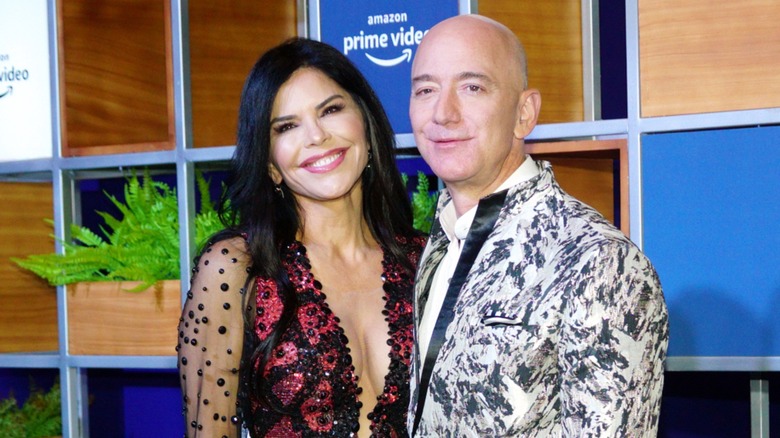 Jeff Bezos and Lauren Sánchez lean toward each other and are all smiles.