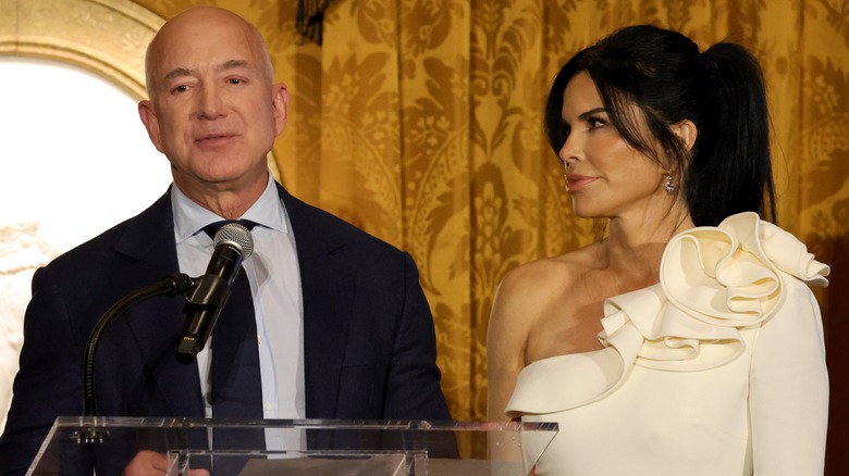 Lauren Sánchez looks at Jeff Bezos as he speaks into the microphone