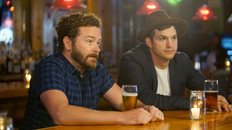 Danny Masterson and Ashton Kutcher in The Ranch still, seated at a bar.