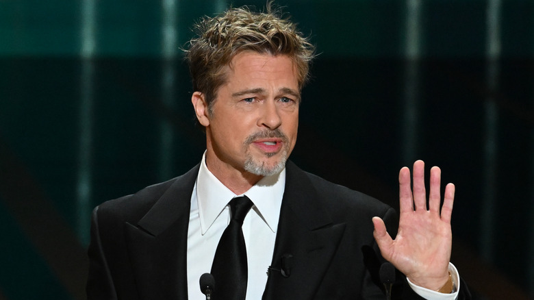 Brad Pitt hand raised