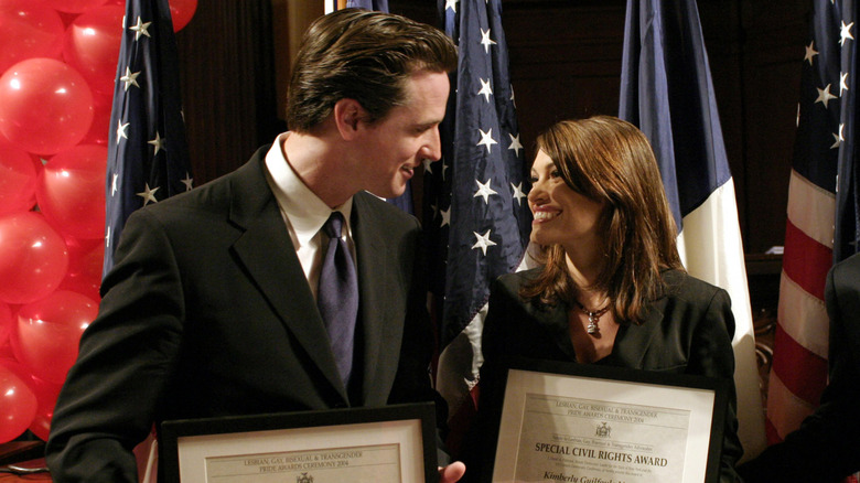 Gavin Newsom and Kimberly Guilfoyle accepting awards on stage while they were still married.