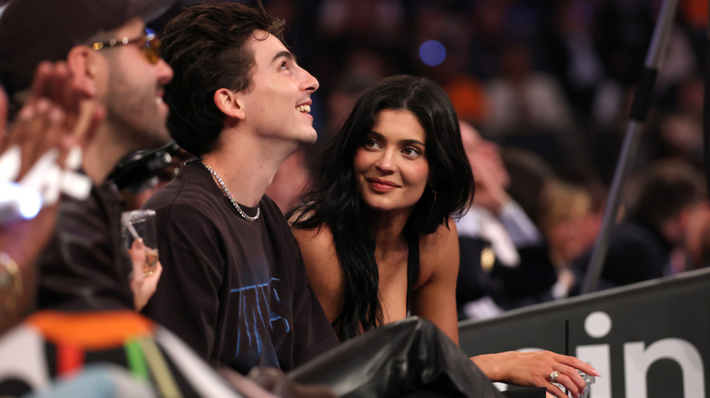 Timothée Chalamet and Kylie Jenner sitting courtside.