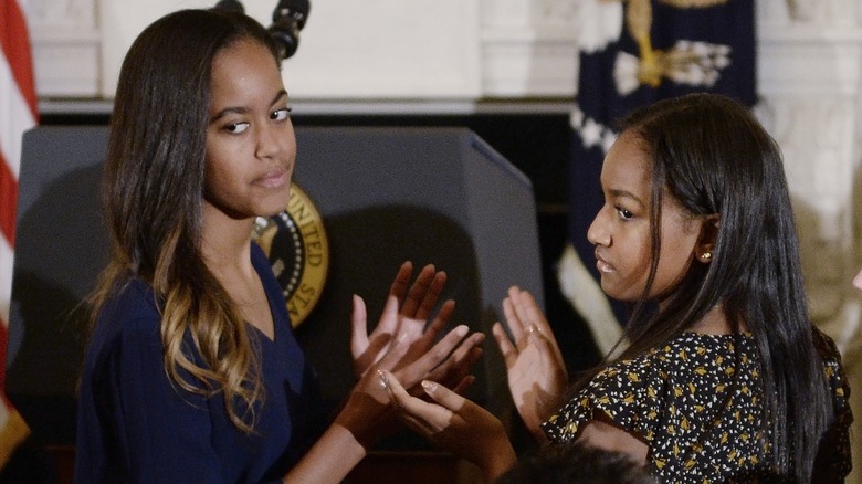 Sasha and Malia Obama clapping