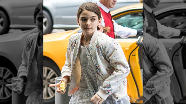Suri Cruise running yellow taxi