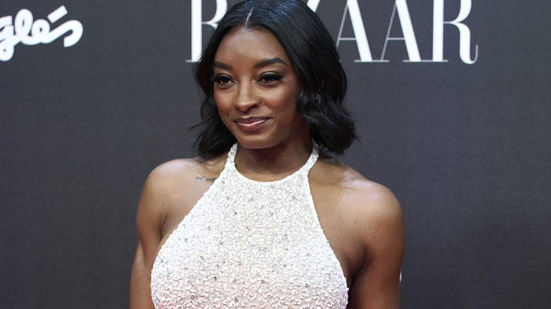 Simone Biles poses in a dress in October 2025