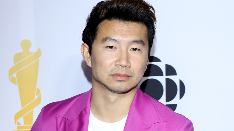 Simu Liu wears a vibrant pink suit