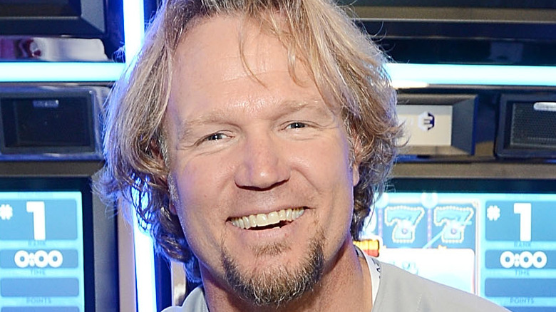 Kody Brown smiling with long hair and goatee